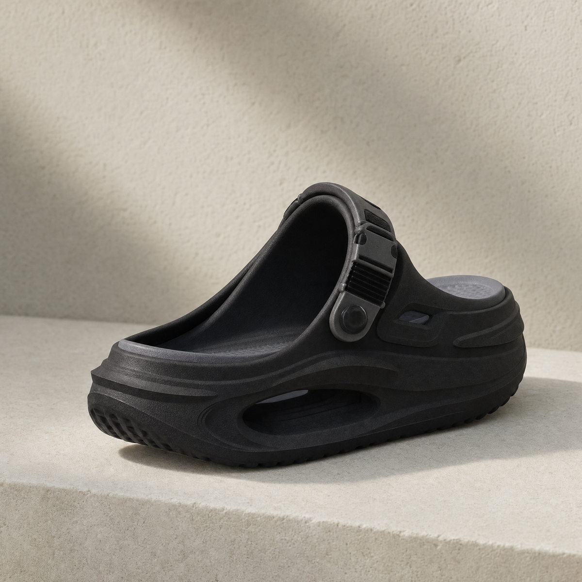 Arch support clog in black on a stone ledge
