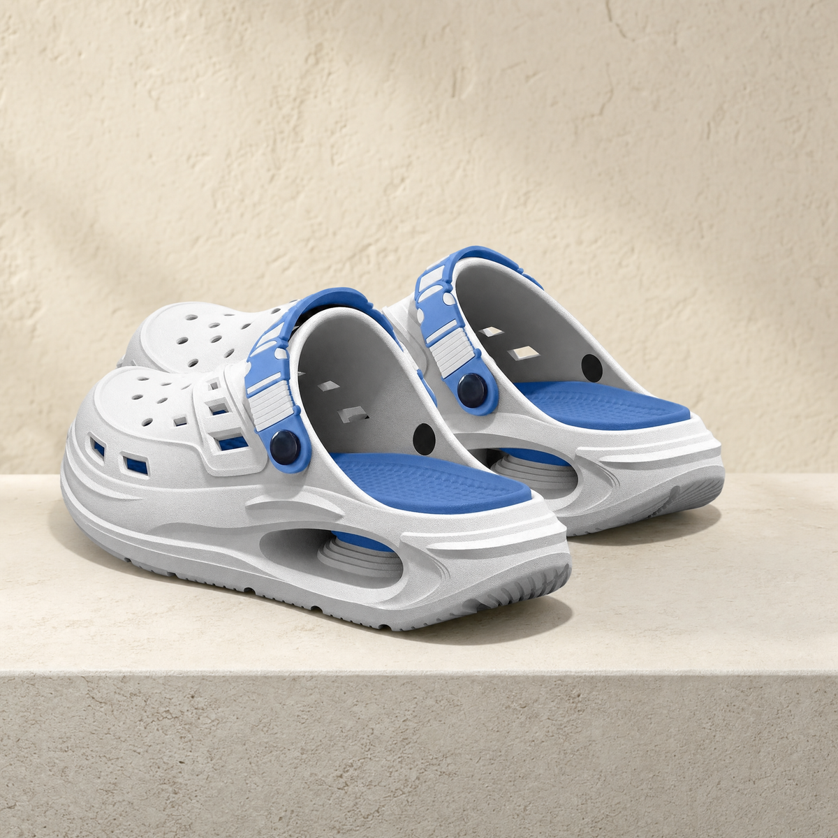 Arch support clog in white and blue on a stone ledge