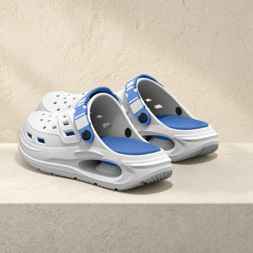 Arch support clog in white and blue on a stone ledge
