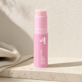 Retinol collagen plumping balm stick on a travertine ledge