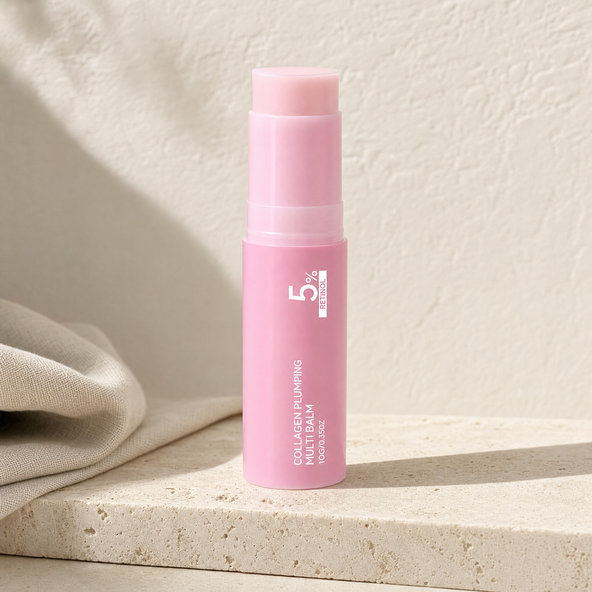 Retinol collagen plumping balm stick on a travertine ledge